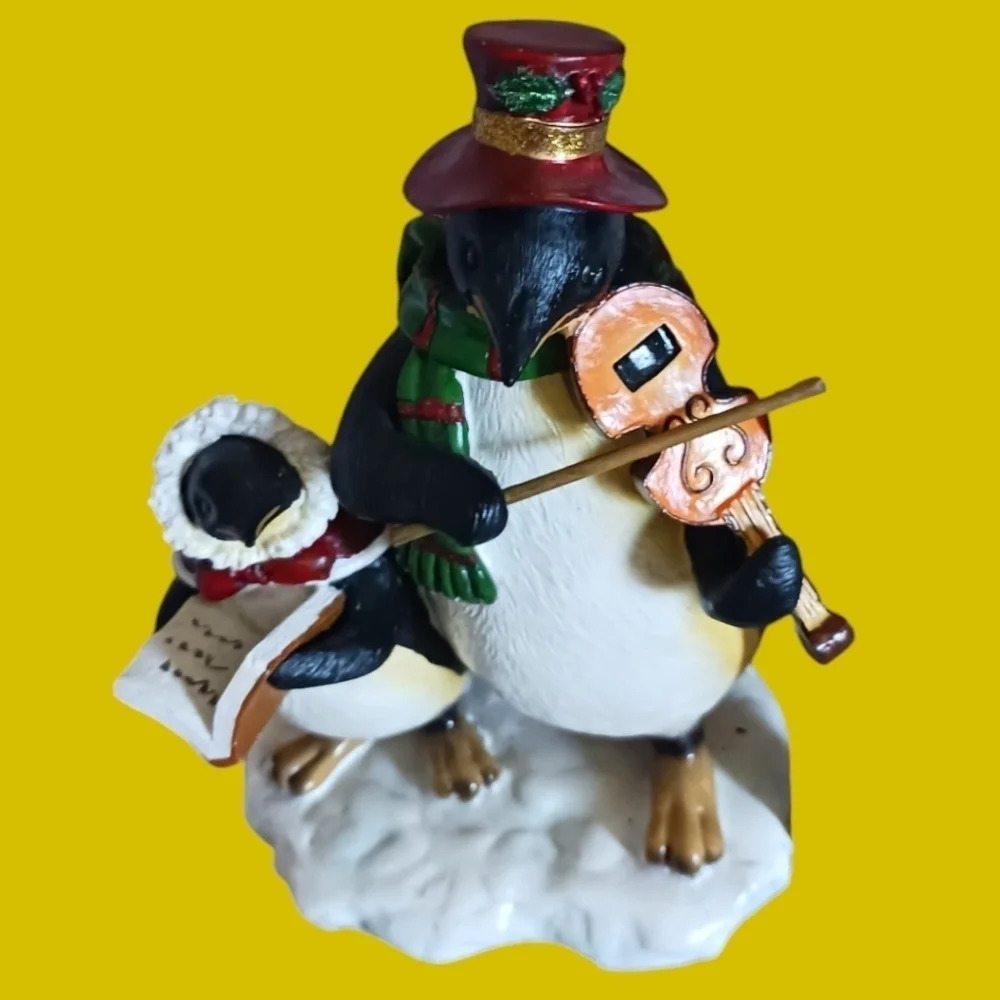 Christmas caroling penguins playing violin